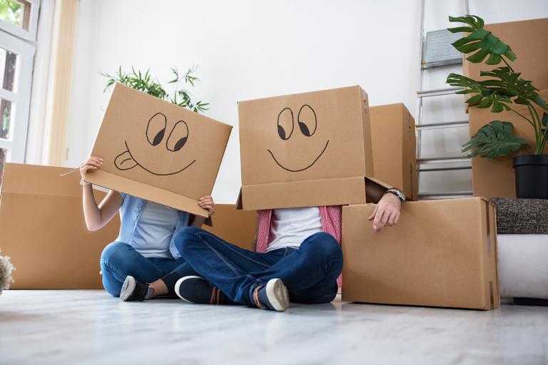 First Time Buyers with boxes on their head in a their new home.